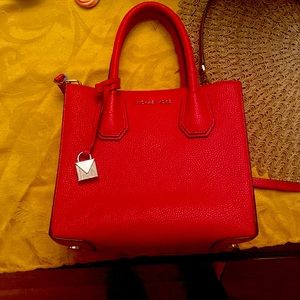 Small, Red Michael Kors crossbody purse.